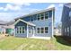 The backyard has green grass, a patio, and a view of other homes at 119 Augusta Pond Way # 147, Raleigh, NC 27603
