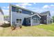 The backyard has green grass with a view of the beautiful blue siding at 119 Augusta Pond Way # 147, Raleigh, NC 27603