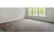 Bedroom featuring neutral walls, carpet flooring, and a bright window at 119 Augusta Pond Way # 147, Raleigh, NC 27603