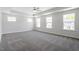 Spacious bedroom with plush carpeting, tray ceiling and multiple windows providing natural light at 119 Augusta Pond Way # 147, Raleigh, NC 27603