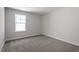 Bedroom featuring neutral walls, carpet flooring, and a bright window at 119 Augusta Pond Way # 147, Raleigh, NC 27603