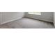 This bedroom features neutral walls and carpet, with a view of the outdoors at 119 Augusta Pond Way # 147, Raleigh, NC 27603