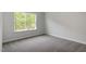 This bedroom has neutral walls, carpeted floor, and a large window at 119 Augusta Pond Way # 147, Raleigh, NC 27603