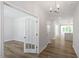 Bright hallway with hardwood floors that guide you to an airy kitchen and living spaces at 119 Augusta Pond Way # 147, Raleigh, NC 27603