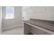 Well-lit laundry room offers counter space, storage, and a window at 119 Augusta Pond Way # 147, Raleigh, NC 27603