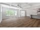 Open-concept living space with a decorative ceiling, hardwood floors, and bright windows at 119 Augusta Pond Way # 147, Raleigh, NC 27603