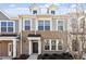 Brick front elevation of charming townhome with gray siding and dormers at 207 Chesapeake Commons Street # 80, Garner, NC 27529
