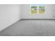 Spacious bedroom with gray carpet and large window offers a calming retreat at 289 Hank Way, Angier, NC 27501