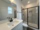 Bathroom with white vanity, shower, and black fixtures at 141 Greenview St, Clayton, NC 27520