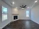 Living room with hardwood floors, fireplace, and ceiling fan at 149 Greenview St, Clayton, NC 27520