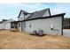 The back exterior of this gray home features a screened-in porch and central air unit at 100 Firefly Ln, Louisburg, NC 27549