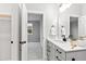 Bright bathroom featuring a single sink vanity and an open door to the bedroom at 100 Firefly Ln, Louisburg, NC 27549