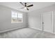 Bright bedroom featuring plush carpeting and a single window allowing natural light at 100 Firefly Ln, Louisburg, NC 27549