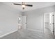Neutral bedroom featuring plush carpeting and an open door to the bathroom at 100 Firefly Ln, Louisburg, NC 27549