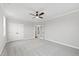 Spacious bedroom with gray carpet, ceiling fan, and a double door closet at 100 Firefly Ln, Louisburg, NC 27549