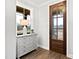 Inviting entryway with decorative cabinet, window, and a wood front door at 100 Firefly Ln, Louisburg, NC 27549