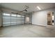 A spacious two car garage with a white garage door, automatic garage door opener, and gray epoxy flooring at 100 Firefly Ln, Louisburg, NC 27549