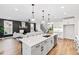 Open-concept kitchen with a central island, modern appliances, and seamless access to the living area at 100 Firefly Ln, Louisburg, NC 27549