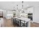 Modern kitchen features a large island, white cabinetry, stainless steel appliances, and ample counter space at 100 Firefly Ln, Louisburg, NC 27549