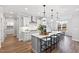 Stylish kitchen features pendant lighting, a spacious island with seating, and contemporary design elements at 100 Firefly Ln, Louisburg, NC 27549
