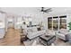 Spacious open-concept living room with natural light, modern furnishings, and seamless flow to the dining area at 100 Firefly Ln, Louisburg, NC 27549
