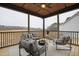 Well decorated and furnished screened porch featuring a wood paneled ceiling, seating, and potted plants at 100 Firefly Ln, Louisburg, NC 27549