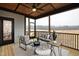 Well decorated screened porch featuring a wood paneled ceiling, ample seating, and an outdoor view at 100 Firefly Ln, Louisburg, NC 27549