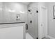 Modern shower with light gray tile, black hardware, glass doors, and recessed niche for storage at 100 Firefly Ln, Louisburg, NC 27549