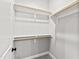 Walk-in closet with carpeted floor and multiple racks installed to maximize storage space at 100 Firefly Ln, Louisburg, NC 27549