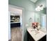 Stylish half bathroom featuring a modern vanity, mirror, and view into the kitchen at 21 Oakbridge Way, Pikeville, NC 27863