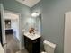 Small bathroom with vanity and toilet, view of kitchen at 21 Oakbridge Way, Pikeville, NC 27863