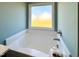 Relaxing soaking tub, offering a serene retreat within the bright bathroom at 21 Oakbridge Way, Pikeville, NC 27863