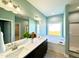 Bright bathroom with dual vanities, a soaking tub, and a separate shower at 21 Oakbridge Way, Pikeville, NC 27863