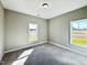 A cozy carpeted bedroom with windows and a calming color scheme at 21 Oakbridge Way, Pikeville, NC 27863