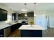 Modern kitchen featuring dark cabinets, stainless steel appliances, and a center island at 21 Oakbridge Way, Pikeville, NC 27863