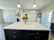 Modern kitchen island with white countertop overlooking the living room and fireplace at 21 Oakbridge Way, Pikeville, NC 27863