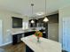 Modern kitchen featuring dark cabinets, stainless steel appliances, and a center island at 21 Oakbridge Way, Pikeville, NC 27863
