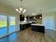 Open kitchen featuring dark cabinetry, stainless steel appliances, and a sliding glass door at 21 Oakbridge Way, Pikeville, NC 27863
