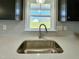 Close up of kitchen sink with white countertops and modern faucet at 21 Oakbridge Way, Pikeville, NC 27863