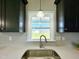 Close up of kitchen sink with white countertops and modern faucet at 21 Oakbridge Way, Pikeville, NC 27863