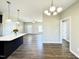 Open-concept living space with dining area, kitchen island, and hardwood flooring at 21 Oakbridge Way, Pikeville, NC 27863