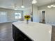 Spacious living area showcasing an island, fireplace, large windows, and modern flooring at 21 Oakbridge Way, Pikeville, NC 27863
