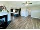 View of the fireplace with living area, opening to a kitchen featuring dark cabinets and an island at 21 Oakbridge Way, Pikeville, NC 27863