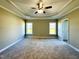 Large main bedroom with a decorative ceiling, a neutral carpet, and great natural light at 21 Oakbridge Way, Pikeville, NC 27863