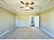 Airy main bedroom with decorative ceiling and an adjoining doorway, with abundant natural light at 21 Oakbridge Way, Pikeville, NC 27863