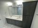 Double vanity bathroom with dark cabinets and marble floors at 3012 Freewinds Way # 44, Cary, NC 27519