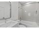 Modern bathroom featuring a stylish vanity, sleek fixtures, and a tiled shower-tub combination for a spa-like experience at 227 Woodsborough Pl, Raleigh, NC 27601