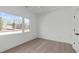 Bright bedroom featuring large windows providing ample natural light, complemented by hardwood flooring and neutral walls at 227 Woodsborough Pl, Raleigh, NC 27601