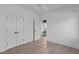 Inviting bedroom featuring a closet, hardwood floors, neutral walls, and an open doorway, creating a cozy atmosphere at 227 Woodsborough Pl, Raleigh, NC 27601