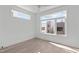 Bright bedroom boasts abundant natural light through large windows, accentuating the hardwood flooring and minimalist design at 227 Woodsborough Pl, Raleigh, NC 27601